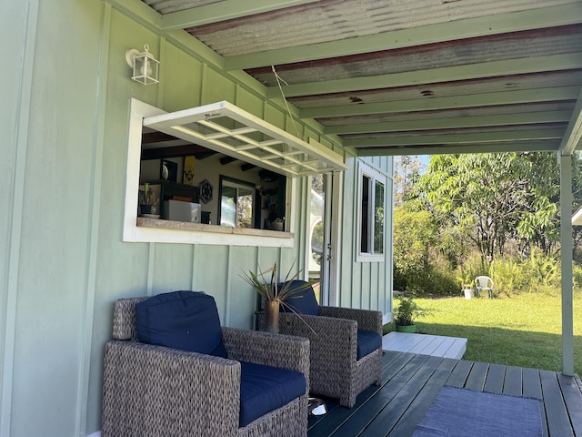 wooden deck featuring a lawn