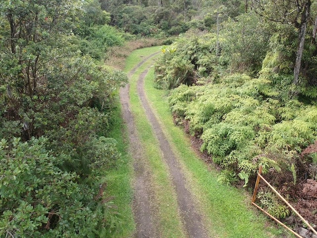 drone / aerial view featuring a forest view