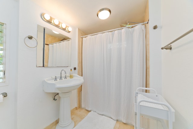 bathroom with tile patterned floors, sink, and a shower with shower curtain