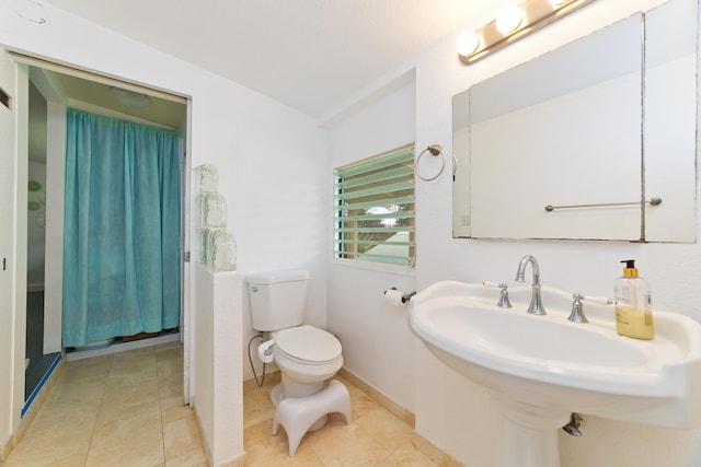 bathroom with tile patterned flooring, toilet, and sink