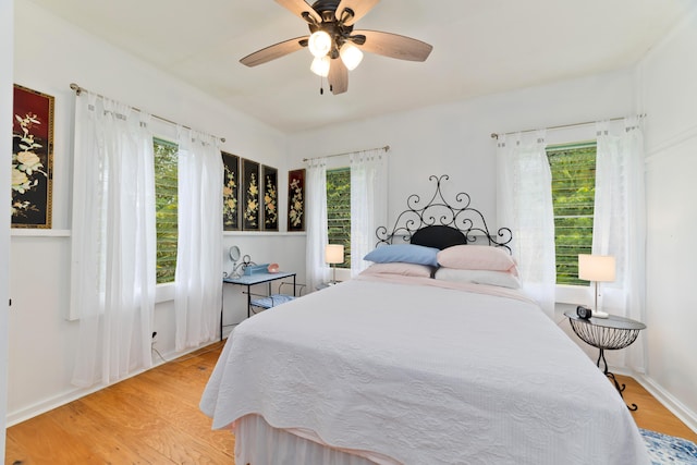 bedroom with ceiling fan and light wood-type flooring