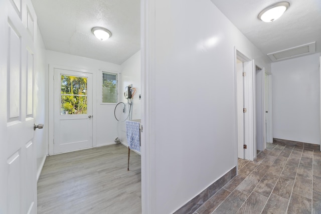 hallway with dark hardwood / wood-style flooring and a textured ceiling