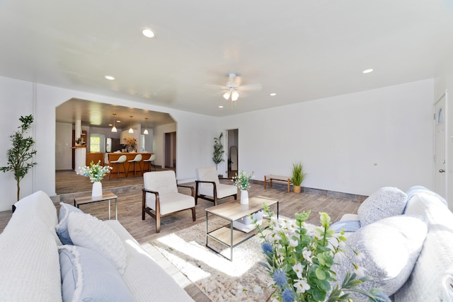 living room featuring light wood-type flooring and ceiling fan