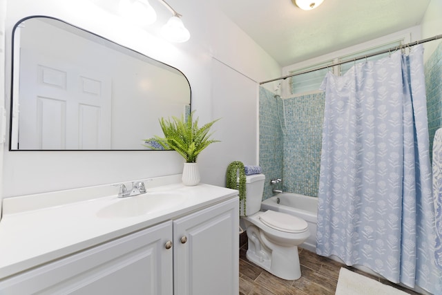 full bathroom featuring shower / bath combo with shower curtain, vanity, and toilet