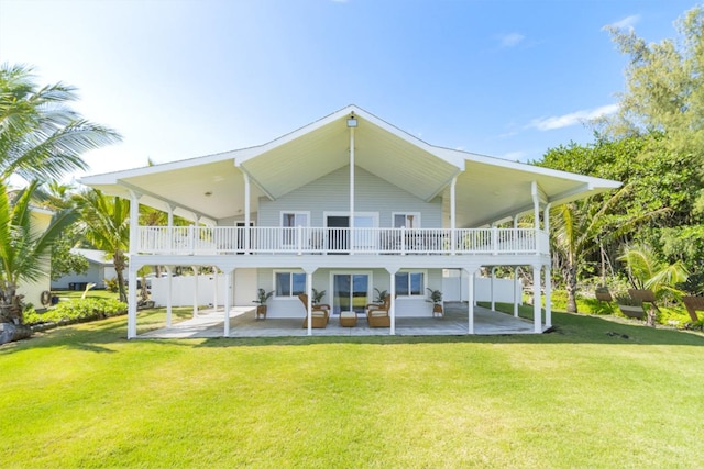 rear view of house featuring outdoor lounge area, a yard, and a patio