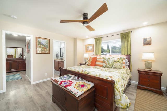 bedroom with connected bathroom, ceiling fan, and light hardwood / wood-style flooring