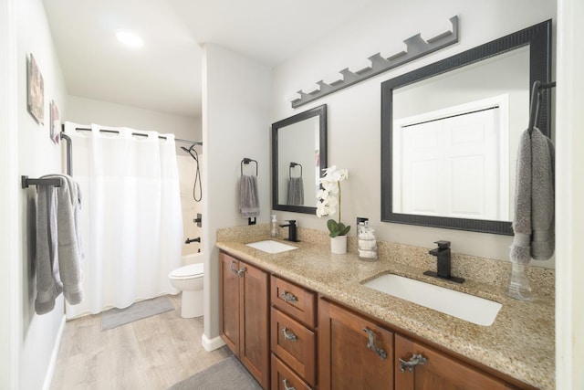 full bathroom with shower / bath combo with shower curtain, toilet, wood-type flooring, and vanity