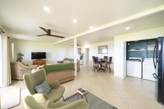 tiled living room with washing machine and dryer and ceiling fan