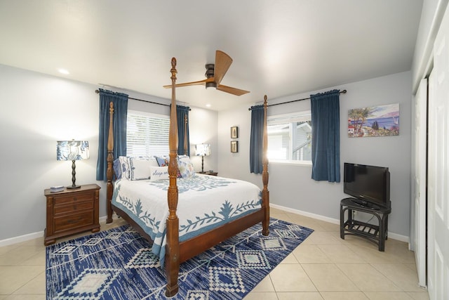 bedroom featuring tile patterned flooring, ceiling fan, and multiple windows