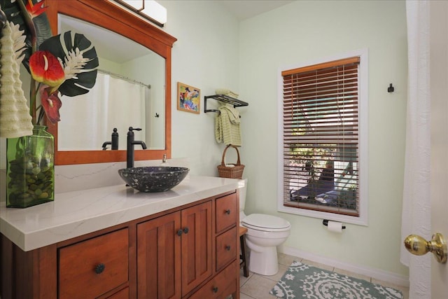 bathroom featuring tile patterned floors, vanity, and toilet