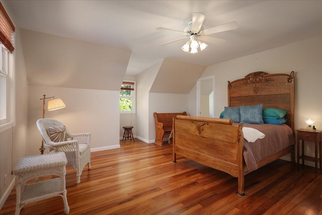 bedroom with hardwood / wood-style flooring, ceiling fan, and lofted ceiling