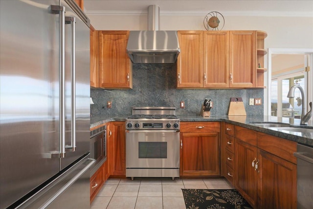 kitchen featuring wall chimney exhaust hood, decorative backsplash, dark stone counters, high quality appliances, and light tile patterned floors