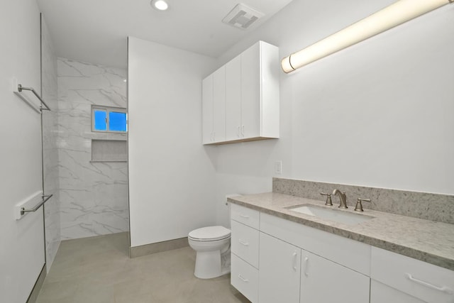 full bath featuring a marble finish shower, visible vents, toilet, vanity, and recessed lighting