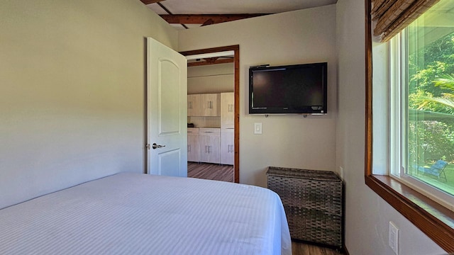 unfurnished bedroom with dark hardwood / wood-style floors and vaulted ceiling