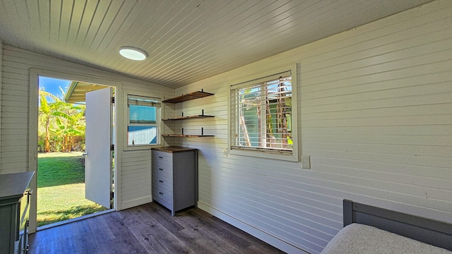 exterior space with dark hardwood / wood-style floors, vaulted ceiling, and wooden walls