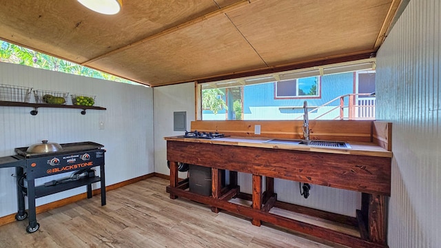 interior space with wood ceiling, sink, light hardwood / wood-style floors, and lofted ceiling