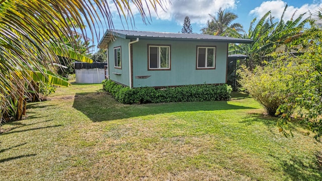 view of side of property with a lawn