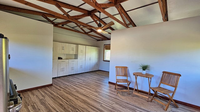 living area with beamed ceiling, wood-type flooring, and high vaulted ceiling