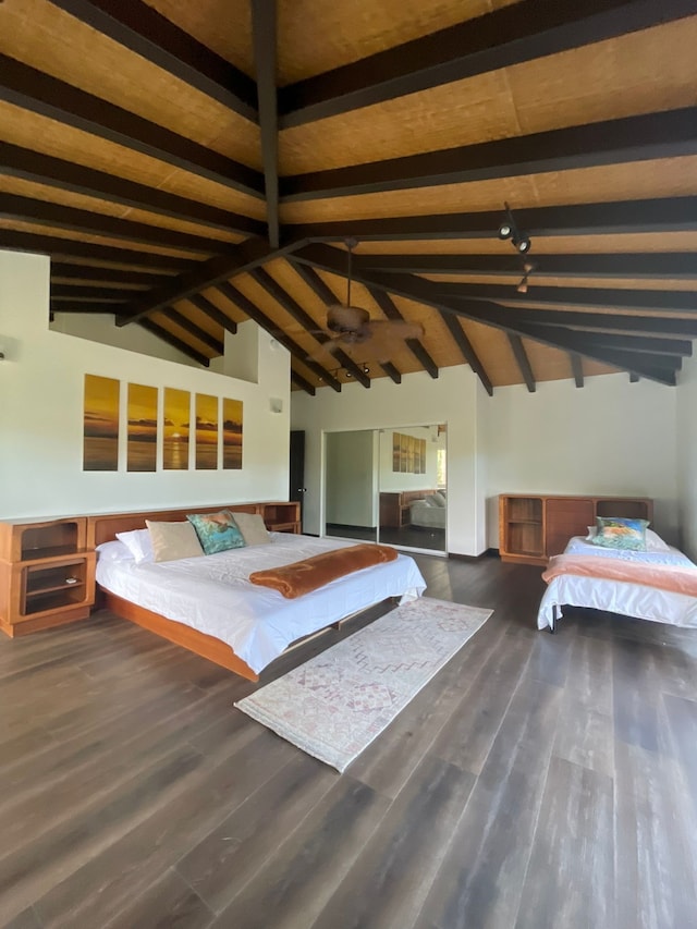 unfurnished bedroom with vaulted ceiling with beams and dark hardwood / wood-style floors