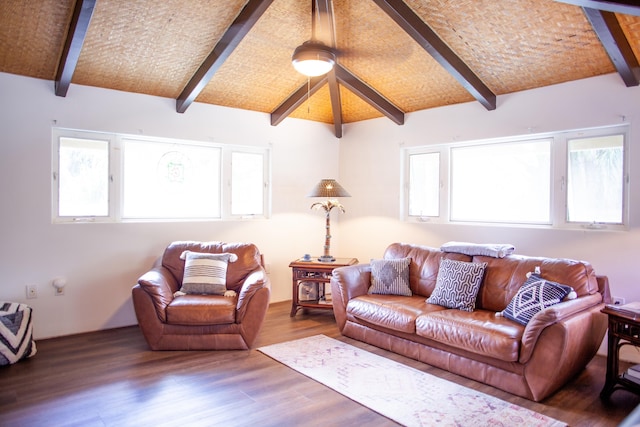 living room with hardwood / wood-style floors, vaulted ceiling with beams, a healthy amount of sunlight, and brick ceiling