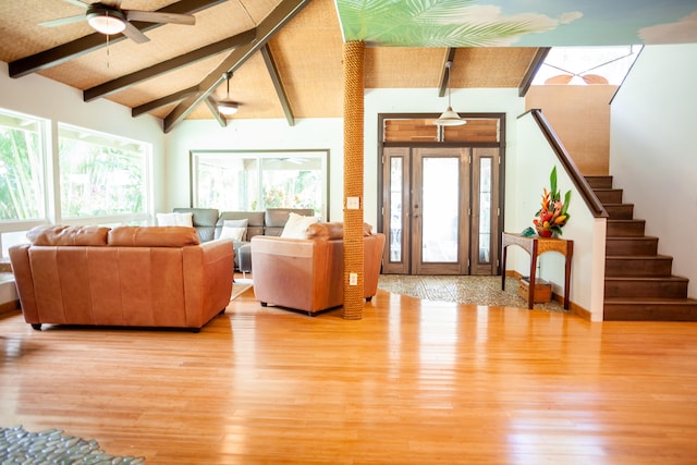 living room featuring vaulted ceiling with beams, ceiling fan, and light hardwood / wood-style floors