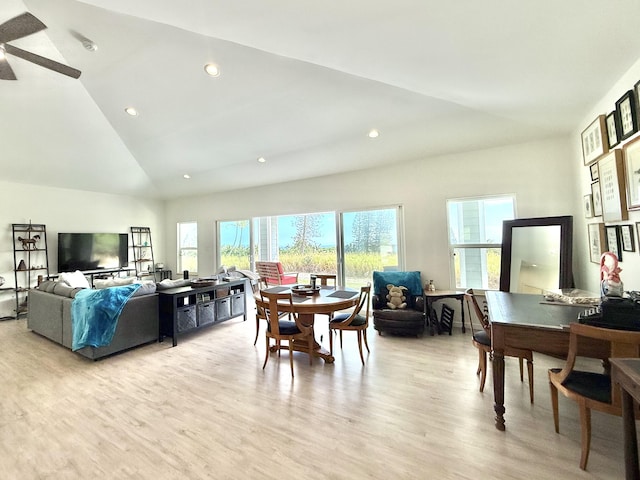 dining area featuring high vaulted ceiling, light hardwood / wood-style flooring, and ceiling fan