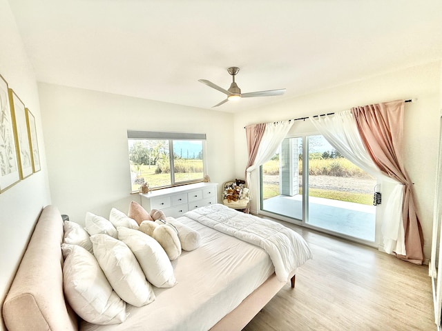 bedroom featuring access to exterior, light wood-type flooring, and ceiling fan