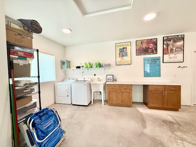 washroom with cabinets, washing machine and dryer, and sink