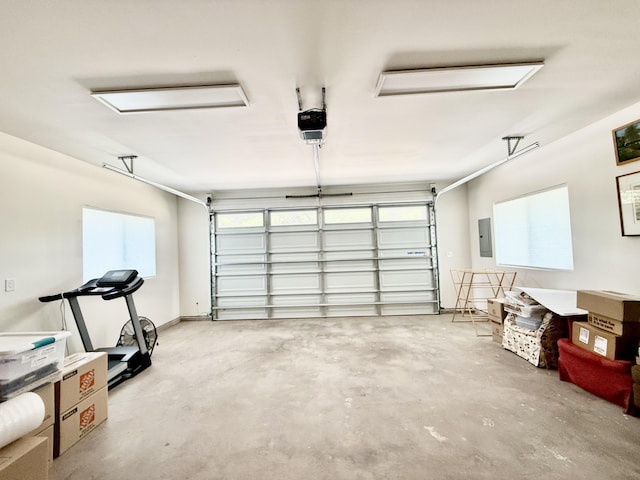 garage featuring electric panel and a garage door opener