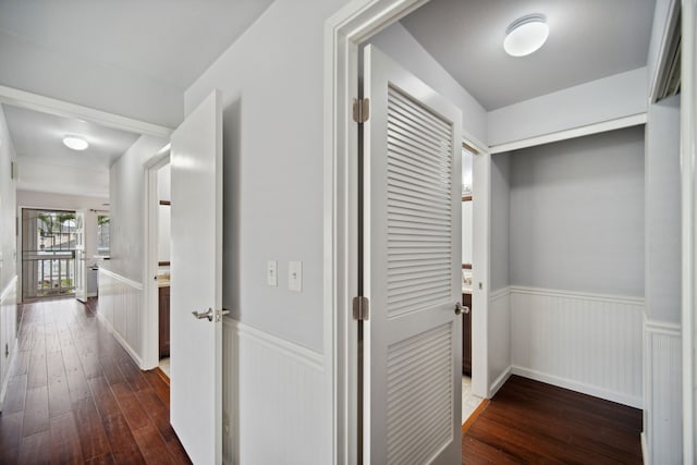 corridor with dark hardwood / wood-style flooring