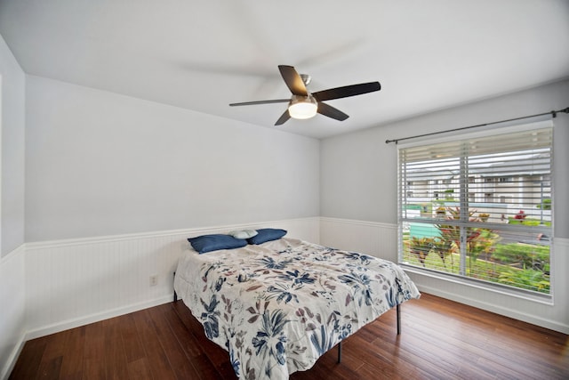 bedroom featuring ceiling fan and dark wood-type flooring