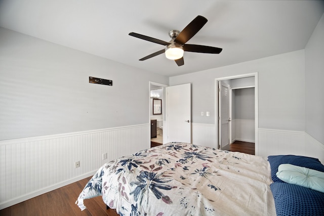 bedroom featuring dark hardwood / wood-style flooring, a closet, and ceiling fan