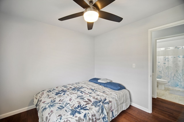 bedroom featuring ceiling fan, dark hardwood / wood-style flooring, and ensuite bathroom