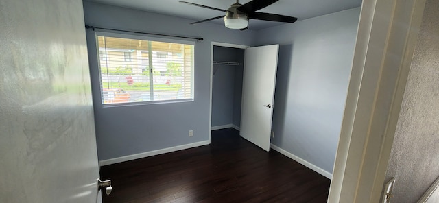 unfurnished bedroom with ceiling fan, a closet, and dark hardwood / wood-style floors