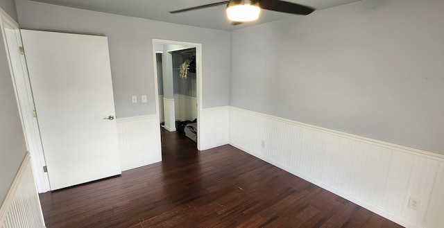 spare room featuring ceiling fan and dark wood-type flooring