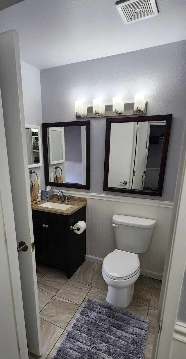 bathroom featuring vanity and toilet