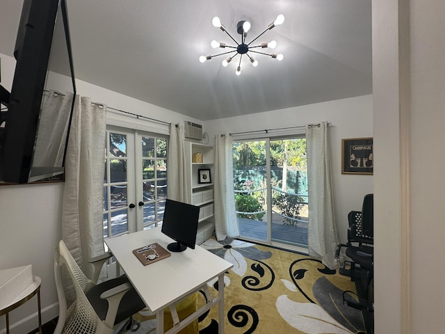 office featuring french doors, an AC wall unit, and an inviting chandelier