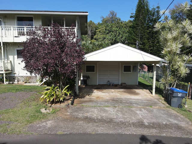 view of front of property with a balcony and a carport