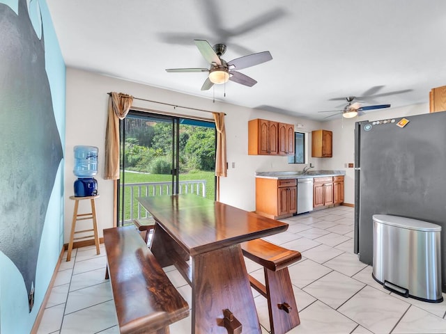 dining area with light tile patterned flooring, ceiling fan, and sink