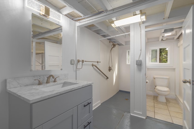 bathroom featuring toilet, vanity, and tile patterned floors