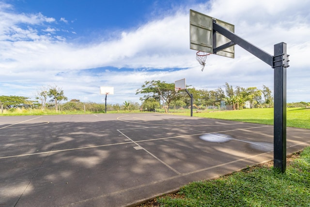 view of sport court with a lawn