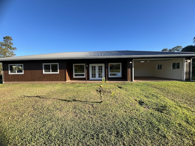 back of house with a lawn and french doors