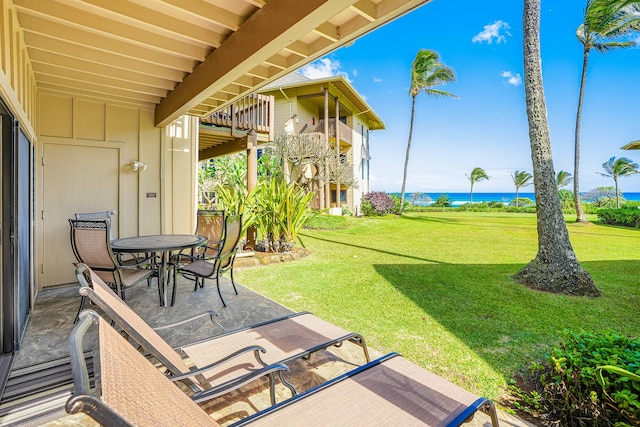 view of yard with a water view and a patio