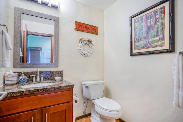 bathroom featuring toilet and vanity