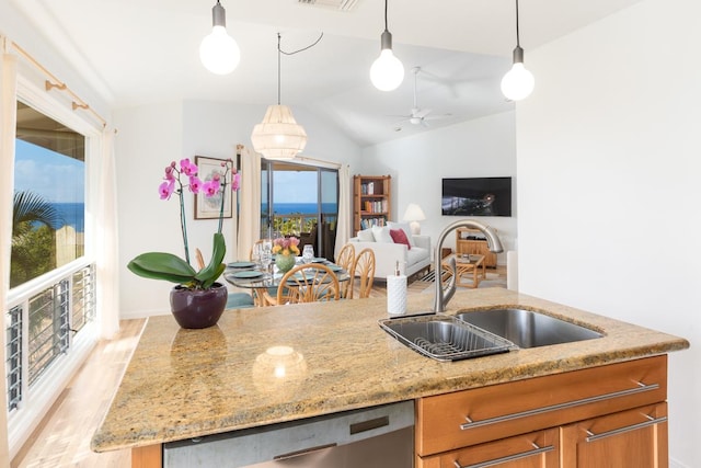 kitchen with sink, dishwasher, lofted ceiling, and decorative light fixtures