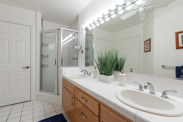 bathroom featuring a shower with shower door, tile patterned floors, ceiling fan, and vanity