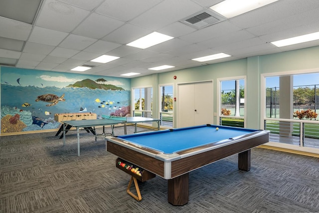 game room featuring dark colored carpet, a paneled ceiling, and pool table