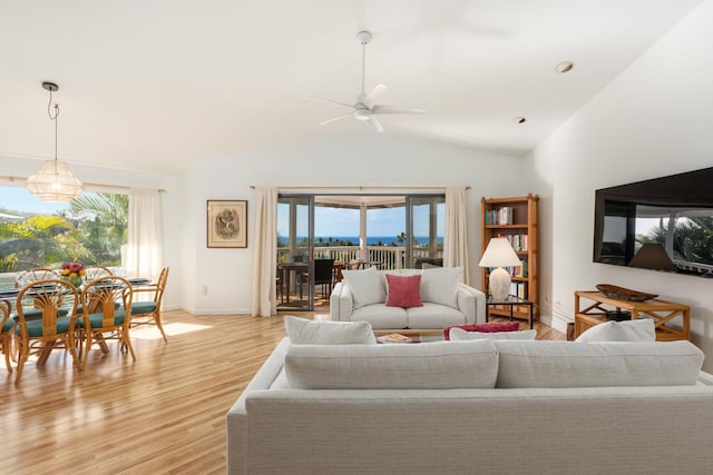 living room featuring light wood-type flooring, ceiling fan, and a wealth of natural light