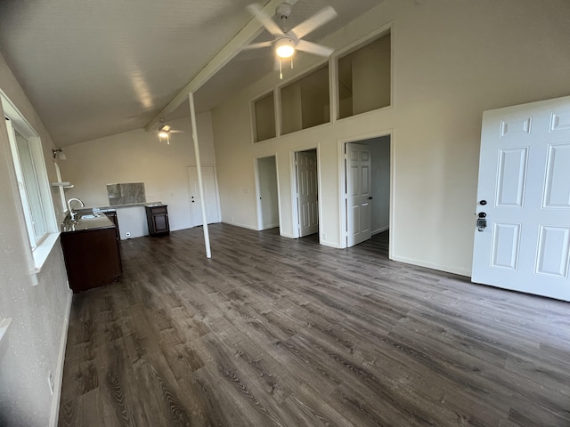 unfurnished living room with ceiling fan, sink, high vaulted ceiling, and dark hardwood / wood-style floors