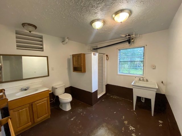 bathroom featuring toilet, a textured ceiling, walk in shower, concrete floors, and vanity